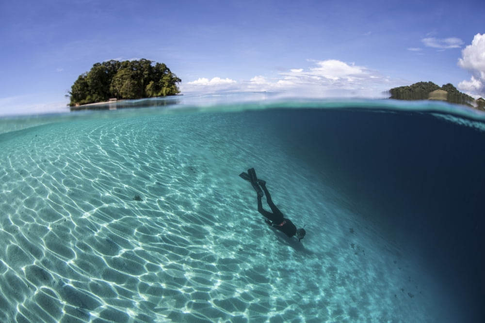 Sunlight dances across a sandy slope off the island of Guadalcanal Canvas Art - Ethan DanielsStocktrek Images (34 x 23)