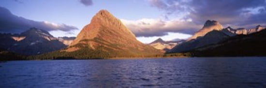 Sunlight falling on mountains at the lakeside Swiftcurrent Lake Many Glacier US Glacier National Park Montana USA Canvas Art - Panoramic Images (36 x 12)