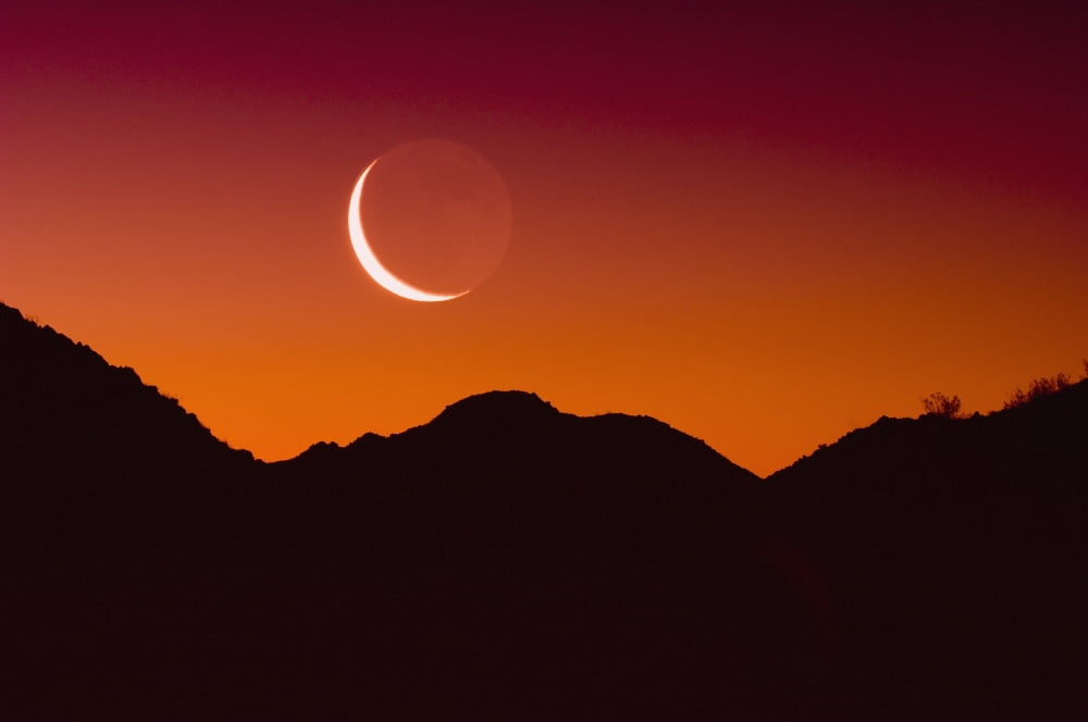 Sunrise over a mountain range in joshua tree national park with the moon in the skyCalifornia united states of america Canvas Art - Brian Guzzetti Design Pics (19 x 12)