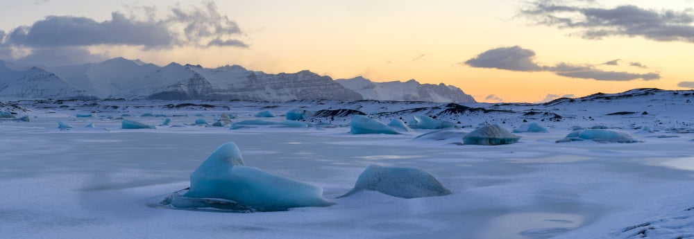 Sunrise over icebergs in frozen lagoon near Breidamerkurjokull glacier Vatnajokull Iceland Canvas Art - Panoramic Images (27 x 9)