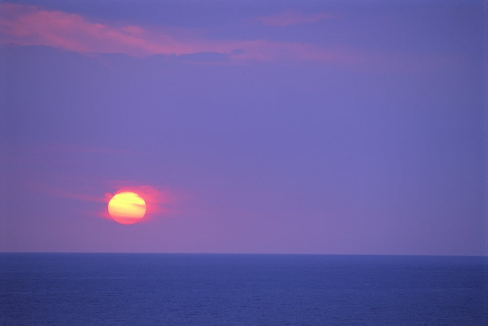 Sunset Over Calm Ocean Sun Ball In Purple Sky Vog (Volcanic Smog) Horizon A29G Canvas Art - Greg Vaughn Design Pics (19 x 12)