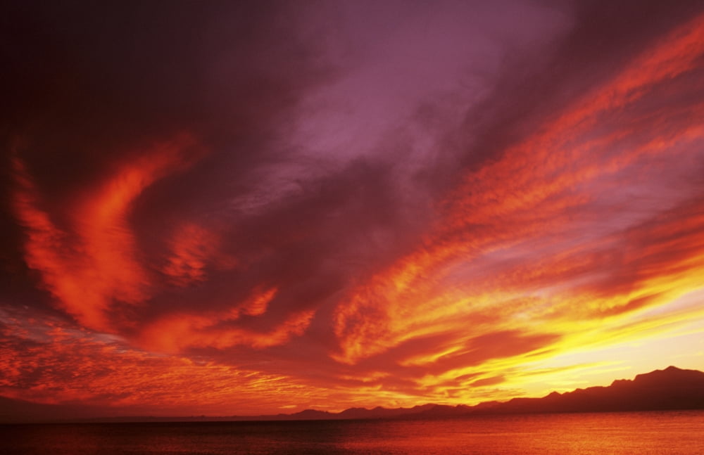 Sunset Over Seascape Brightly Colored Clouds Illuminated Over Ocean Canvas Art - Larry Dale Gordon Design Pics (17 x 11)