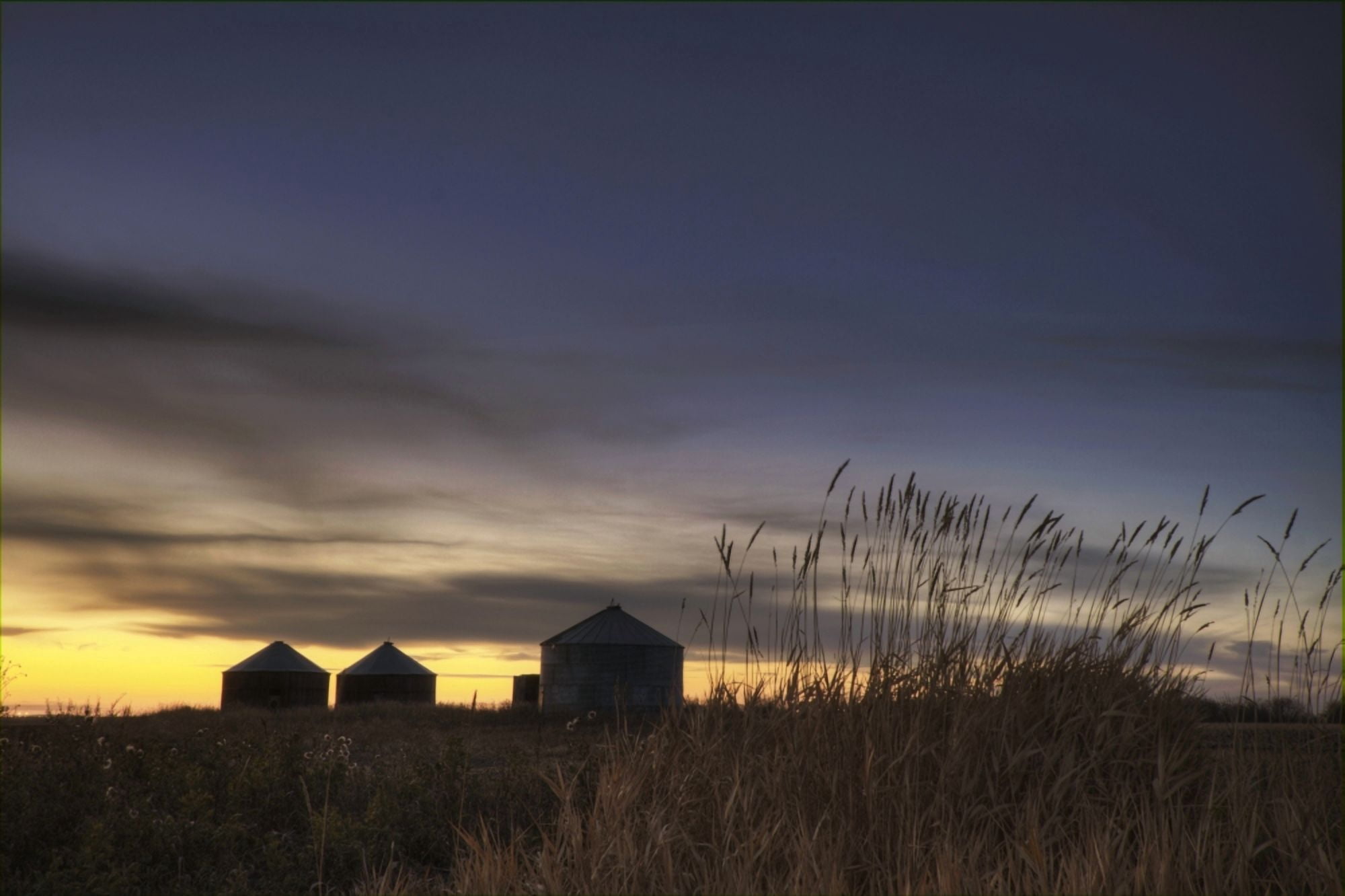 Sunset Silhouetting Grain Silos In Autumn Rural Alberta Canvas Art - Dan Jurak Design Pics (34 x 22)