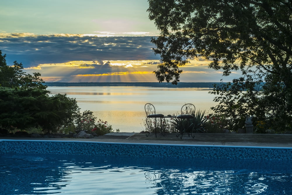 Sunset over the St Lawrence river and a residential swimming pool in the foreground Prince Edward County Ontario Canada Canvas Art - Jacques Laurent Design Pics (19 x 12)