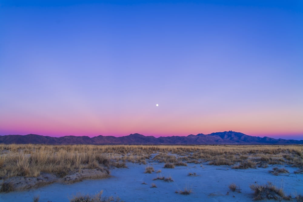 Sunset and gibbous moon above the Chiricahua Mountains in Arizona Canvas Art - Alan DyerStocktrek Images (17 x 12)