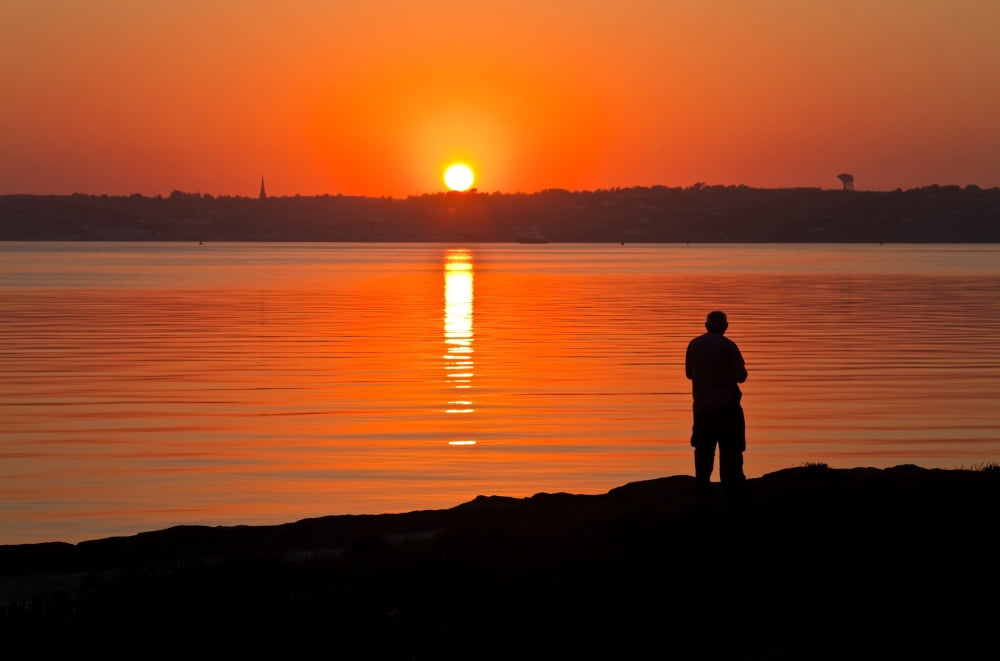 Sunset and lone figure Cork Harbour with Cobh on far side County Cork Ireland Canvas Art - Panoramic Images (9 x 27)