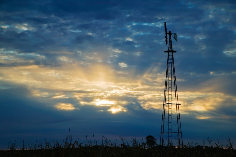 Sunset light through heavy clouds silhouetted windmill Iowa USA Canvas Art - Panoramic Images (36 x 12)