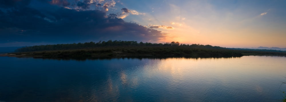 Sunset over a lake Chitwan National Park Western Terai Nepal Canvas Art - Panoramic Images (36 x 12)