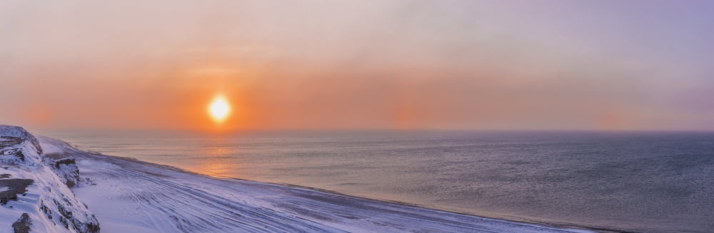 Sunset through windblown snow creates a sundog above the Beaufort Sea along the coast just outside of Barrow Winter Arctic Alaska USA Canvas Art - Kevin Smith Design Pics (44 x 15)