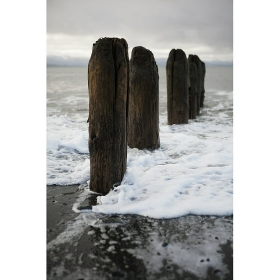 Surf Rising Against Wooden Tide Posts In Kachemak Bay; Alaska United States Of America by Scott Dickerson / Design Pics