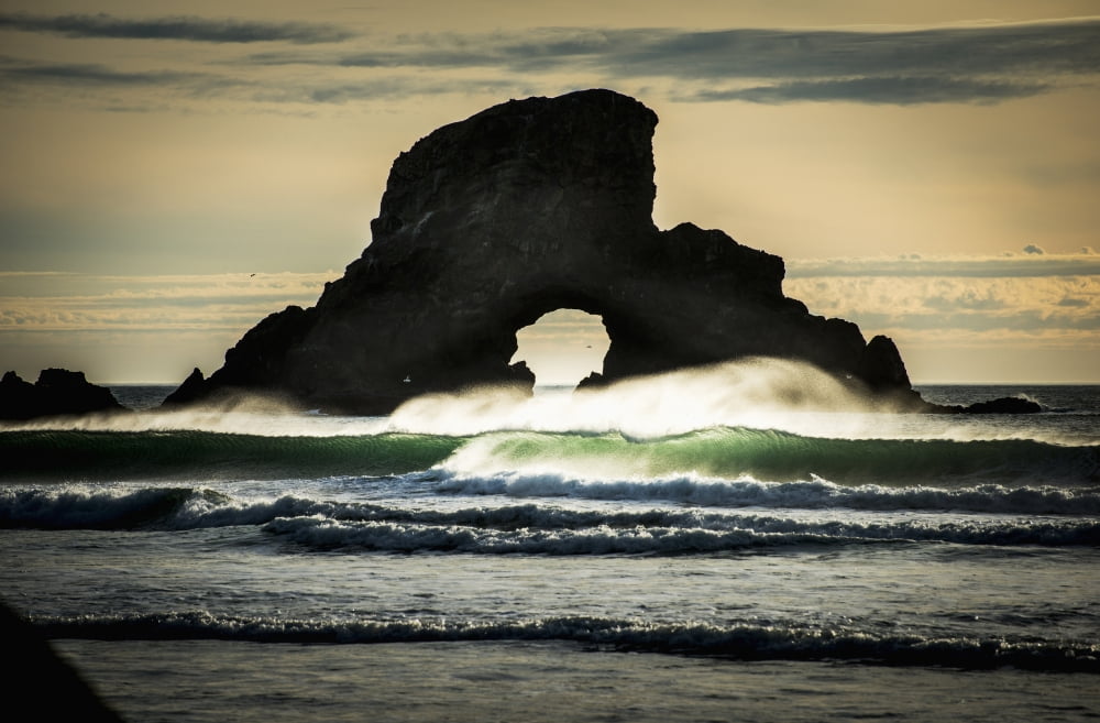 Surf breaks near a natural arch Cannon Beach Oregon United States of America Canvas Art - Robert L Potts  Design Pics (38 x 24)