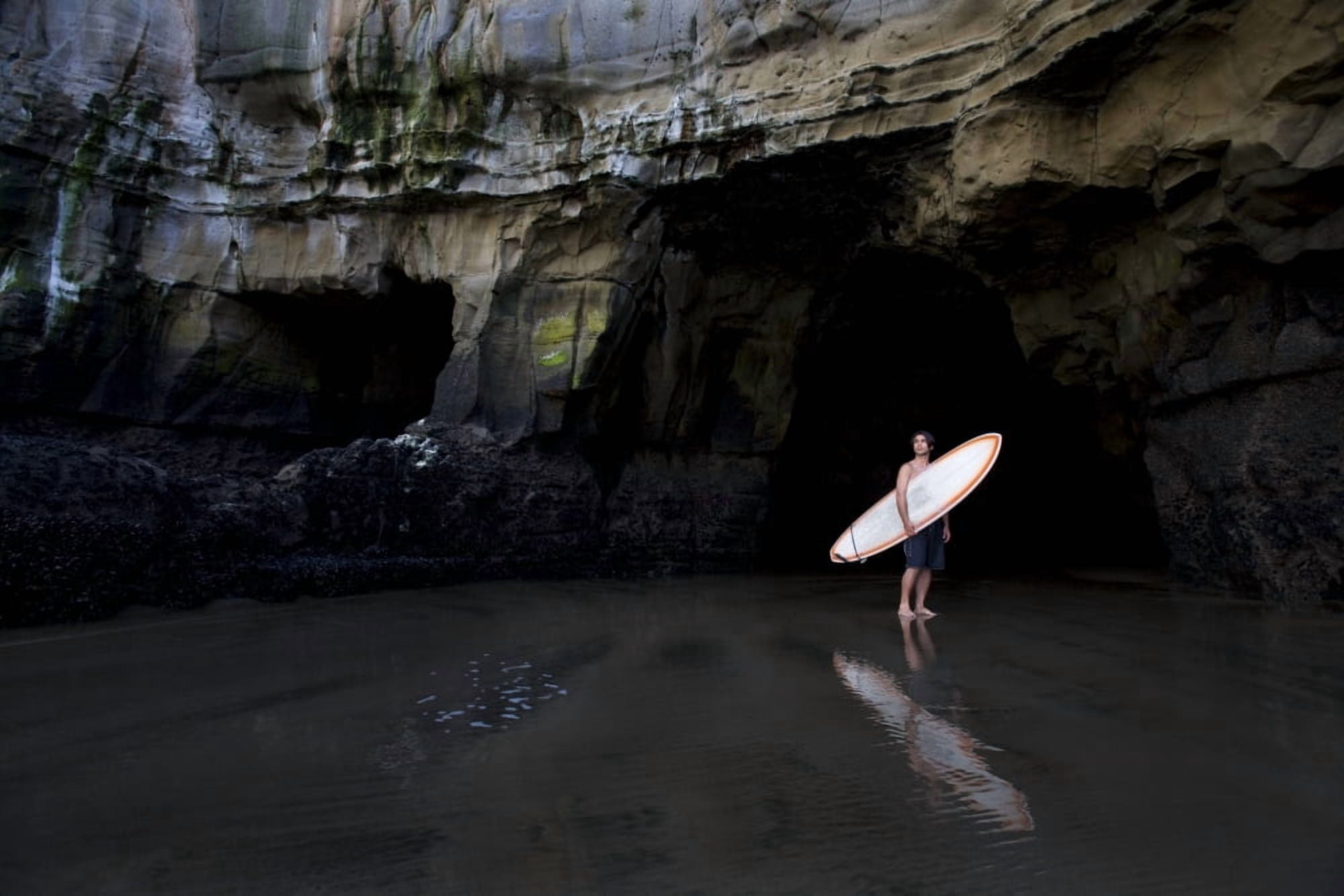 Surfer Inside A Cave At Muriwai New Zealand Canvas Art - Deddeda Design Pics (17 x 11)
