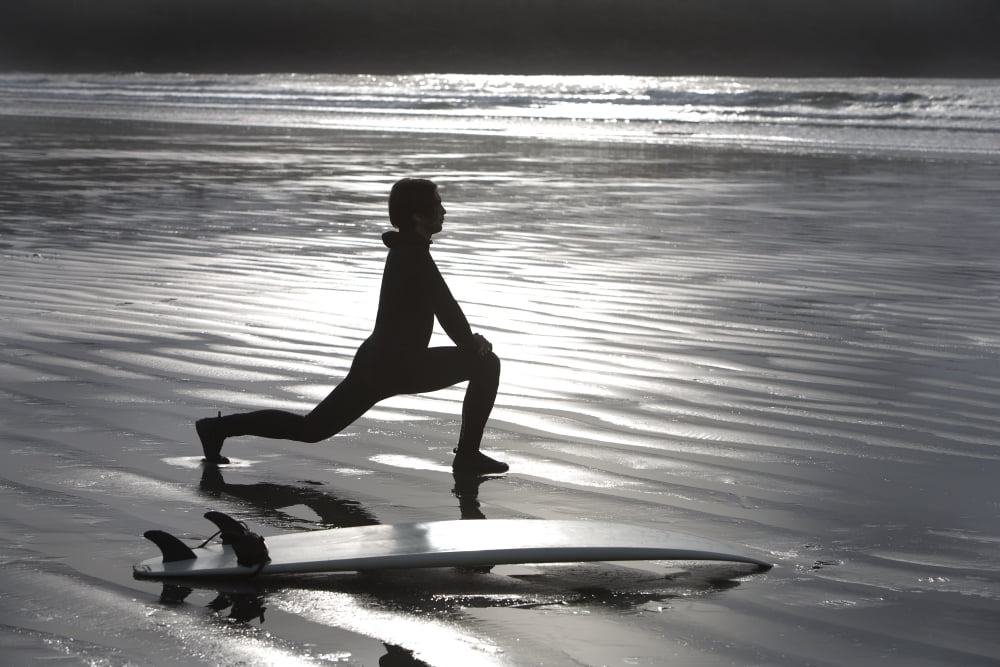 Surfer Stretching On Beach Canvas Art - Deddeda Design Pics (34 x 22)