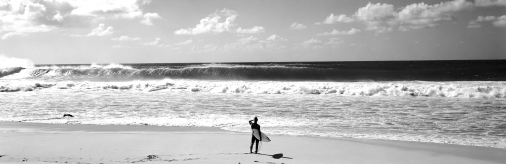 Surfer standing on the beach North Shore Oahu Hawaii USA Canvas Art - Panoramic Images (6 x 18)
