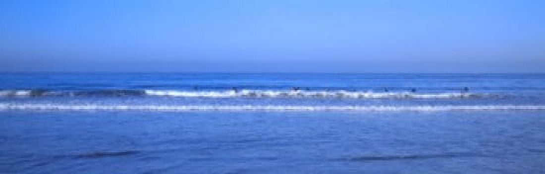 Surfers riding a wave in the sea Santa Monica Los Angeles County California USA Canvas Art - Panoramic Images (18 x 6)