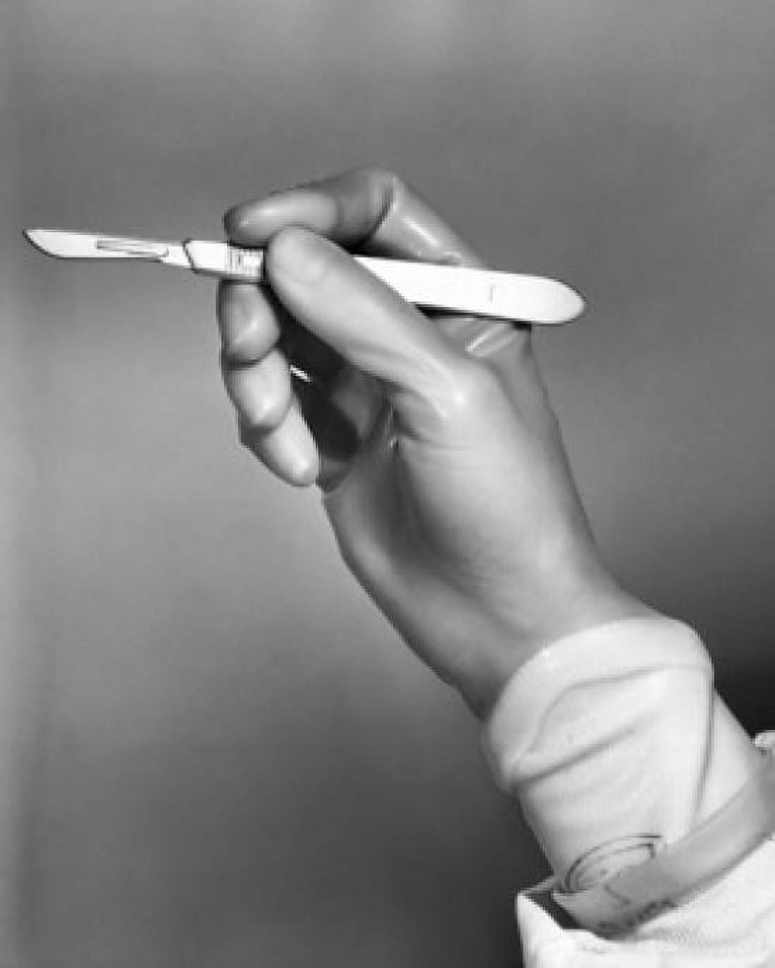 Surgeons hand holding a scalpel Canvas Art - (18 x 24)