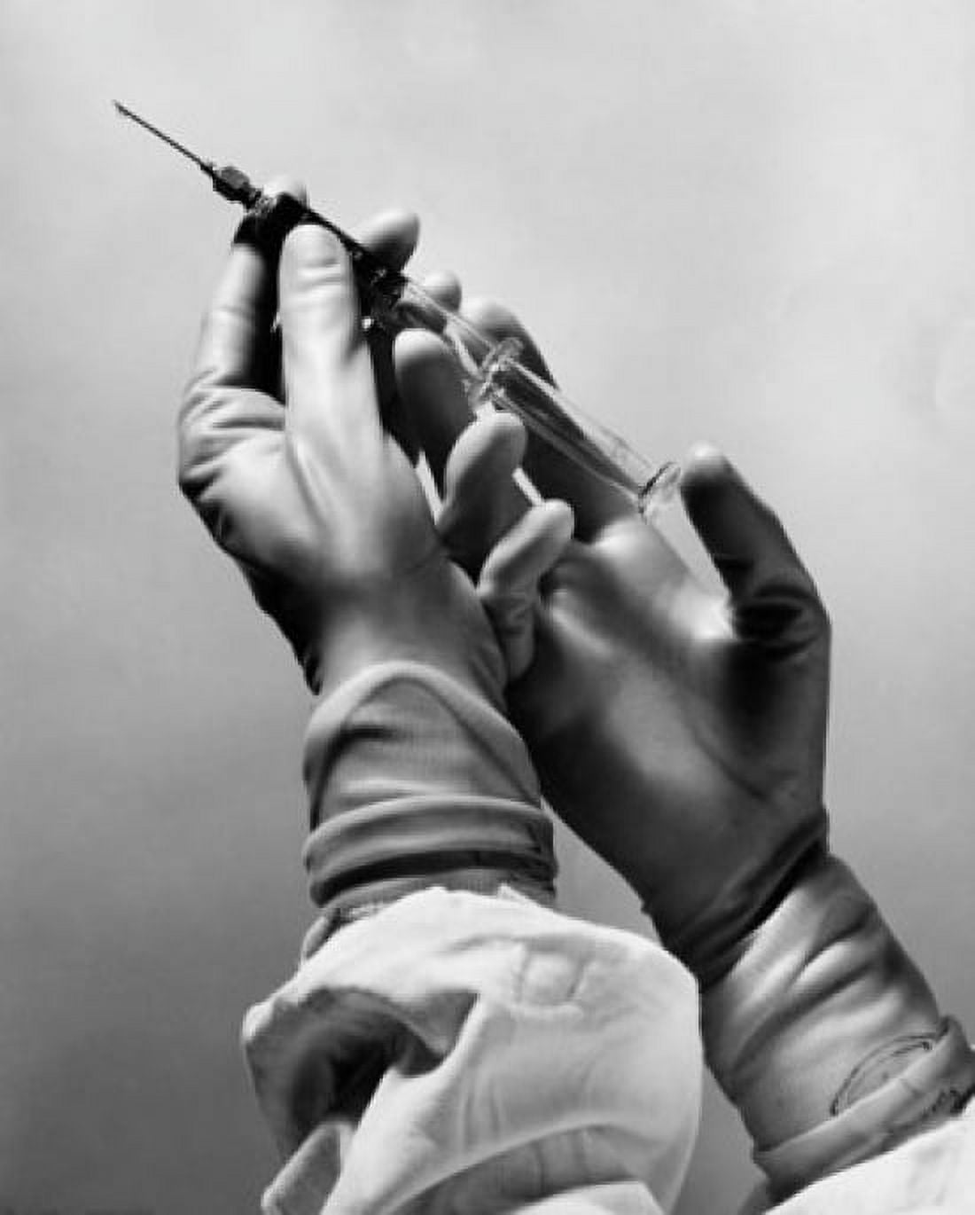 Surgeons hands holding a syringe Canvas Art - (18 x 24)