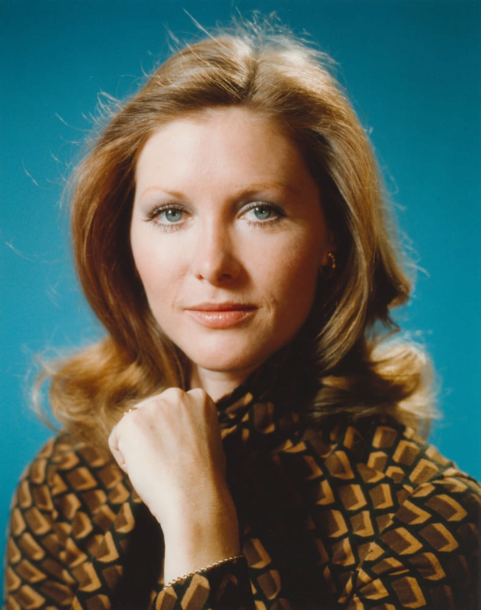 Susan Howard Posed in Blue Background Portrait wearing Printed Formal