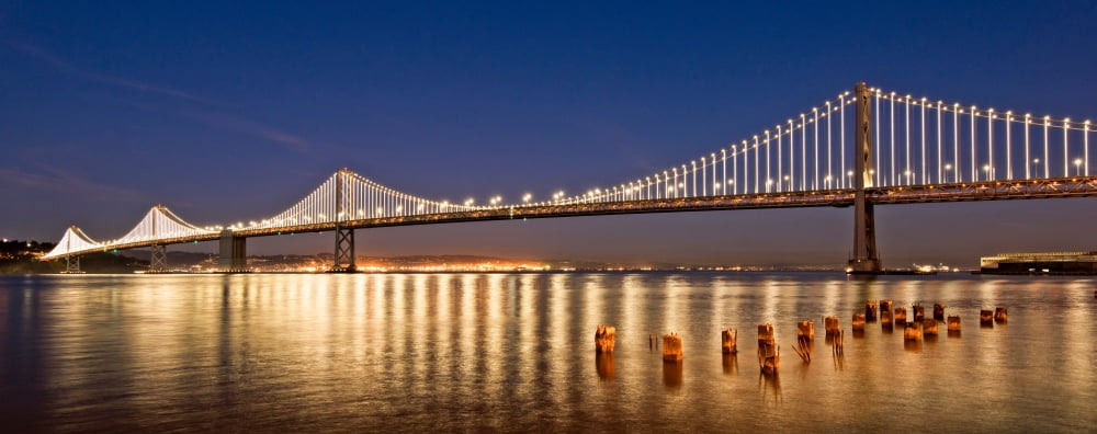 Suspension bridge over Pacific ocean lit up at night Bay Bridge San Francisco Bay San Francisco California USA Canvas Art - Panoramic Images (12 x 30)