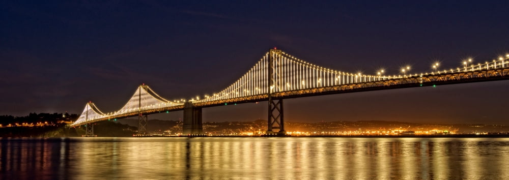 Suspension bridge over Pacific ocean lit up at night Bay Bridge San Francisco Bay San Francisco California USA Canvas Art - Panoramic Images (13 x 36)