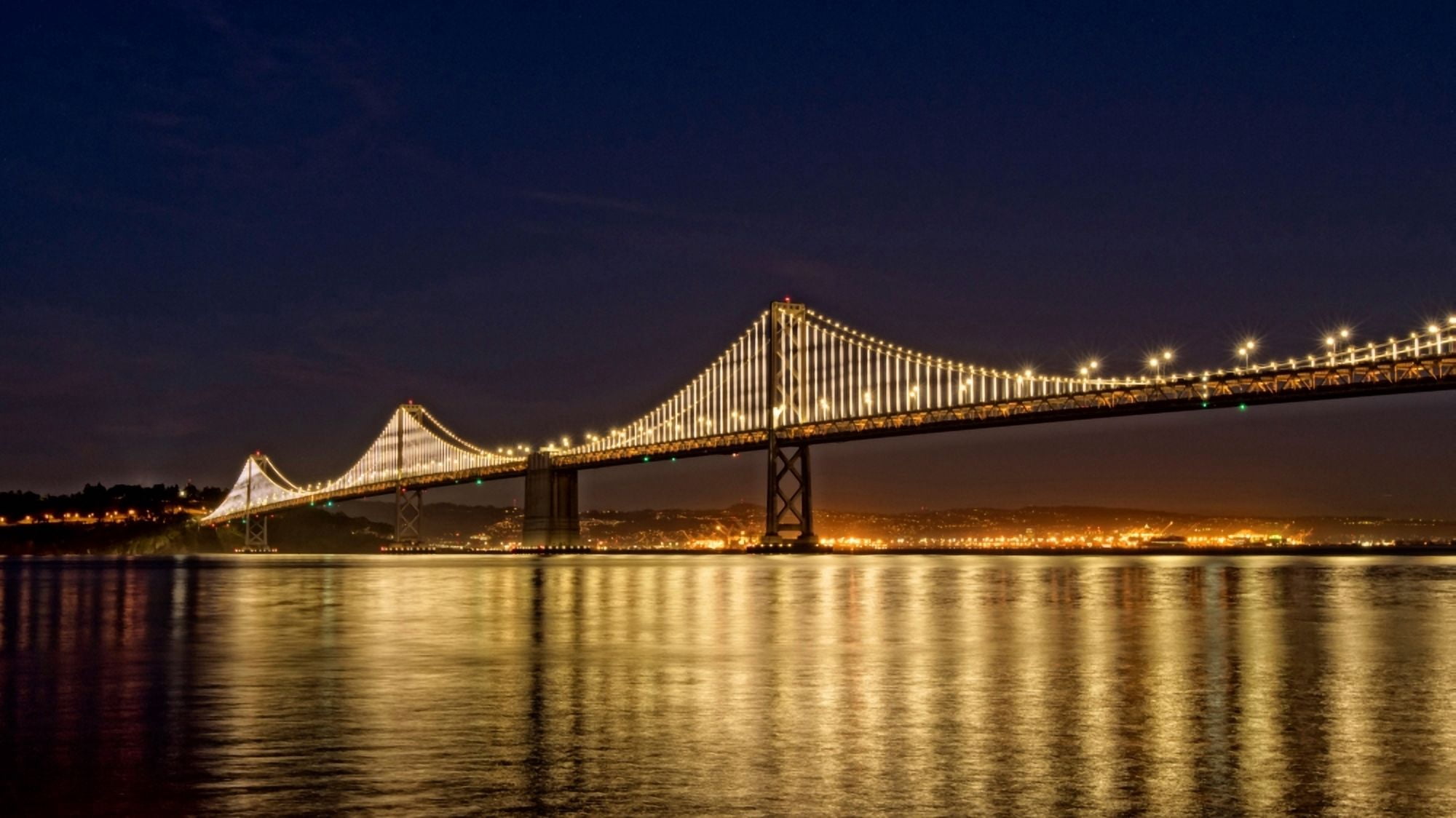 Suspension bridge over Pacific ocean lit up at night Bay Bridge San Francisco Bay San Francisco California USA Canvas Art - Panoramic Images (14 x 24)