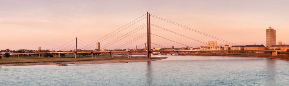 Suspension bridge across a river Rheinkniebrucke Bridge River Rhine Dusseldorf North Rhine Westphalia Germany Canvas Art - Panoramic Images (27 x 9)