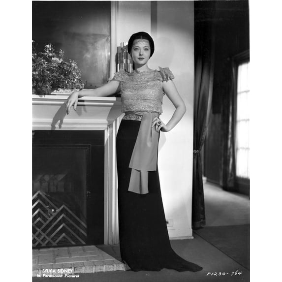 Sylvia Sidney posed Beside the Fireplace and Hand on Waist Photo Print (8 x 10)