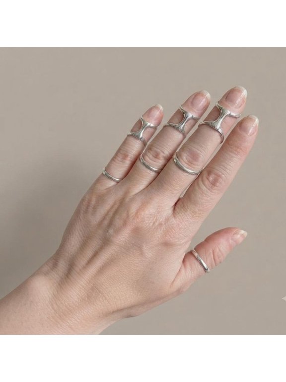 - Adjustable silver ring with geometric open band, H-bridge detail and polished finish for stackable wear