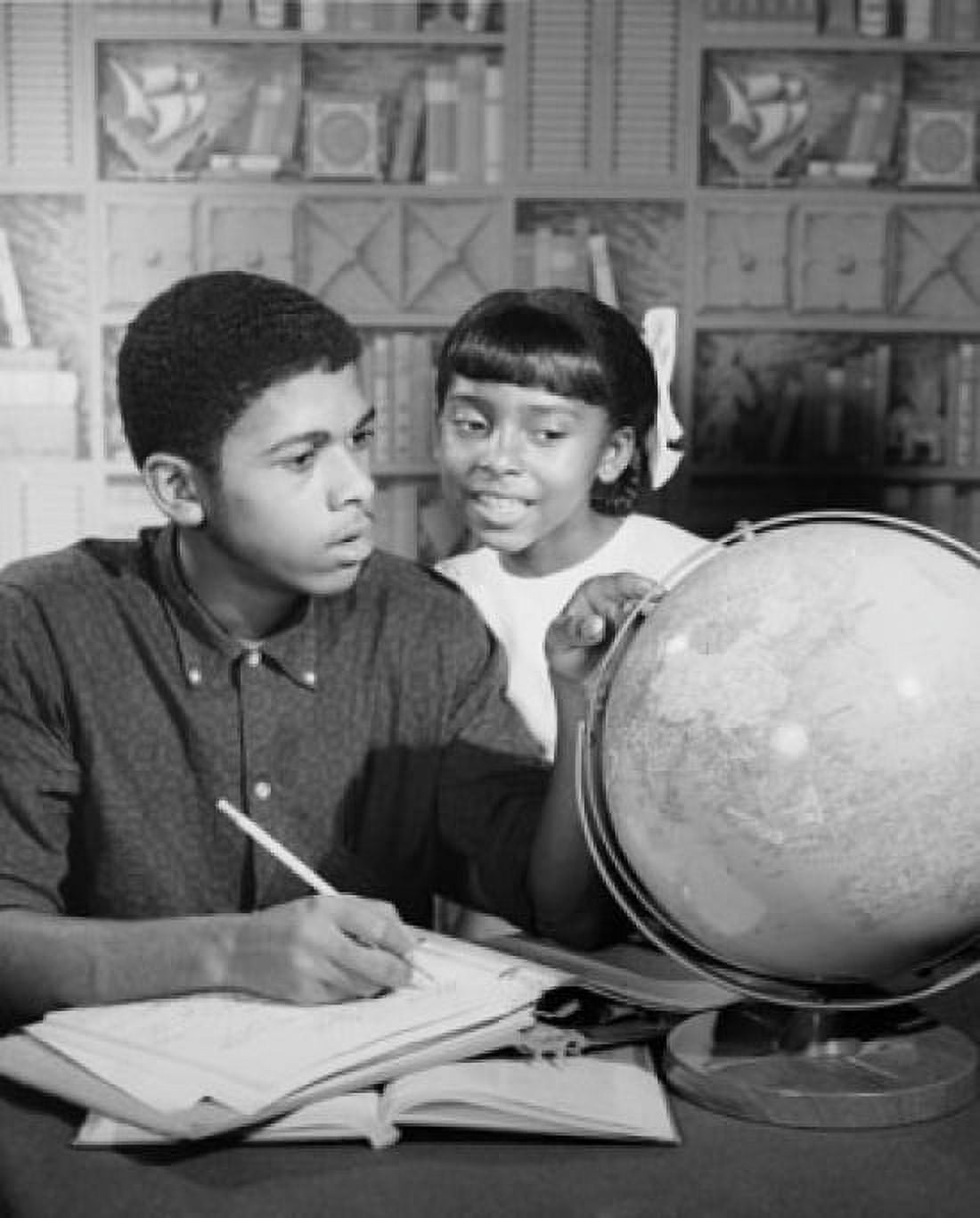 Teenage boy and his sister looking at a globe Canvas Art - (18 x 24)