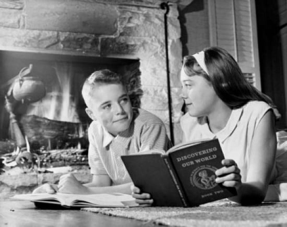 Teenage boy and teenage girl looking at each other while studying Canvas Art - (18 x 24)