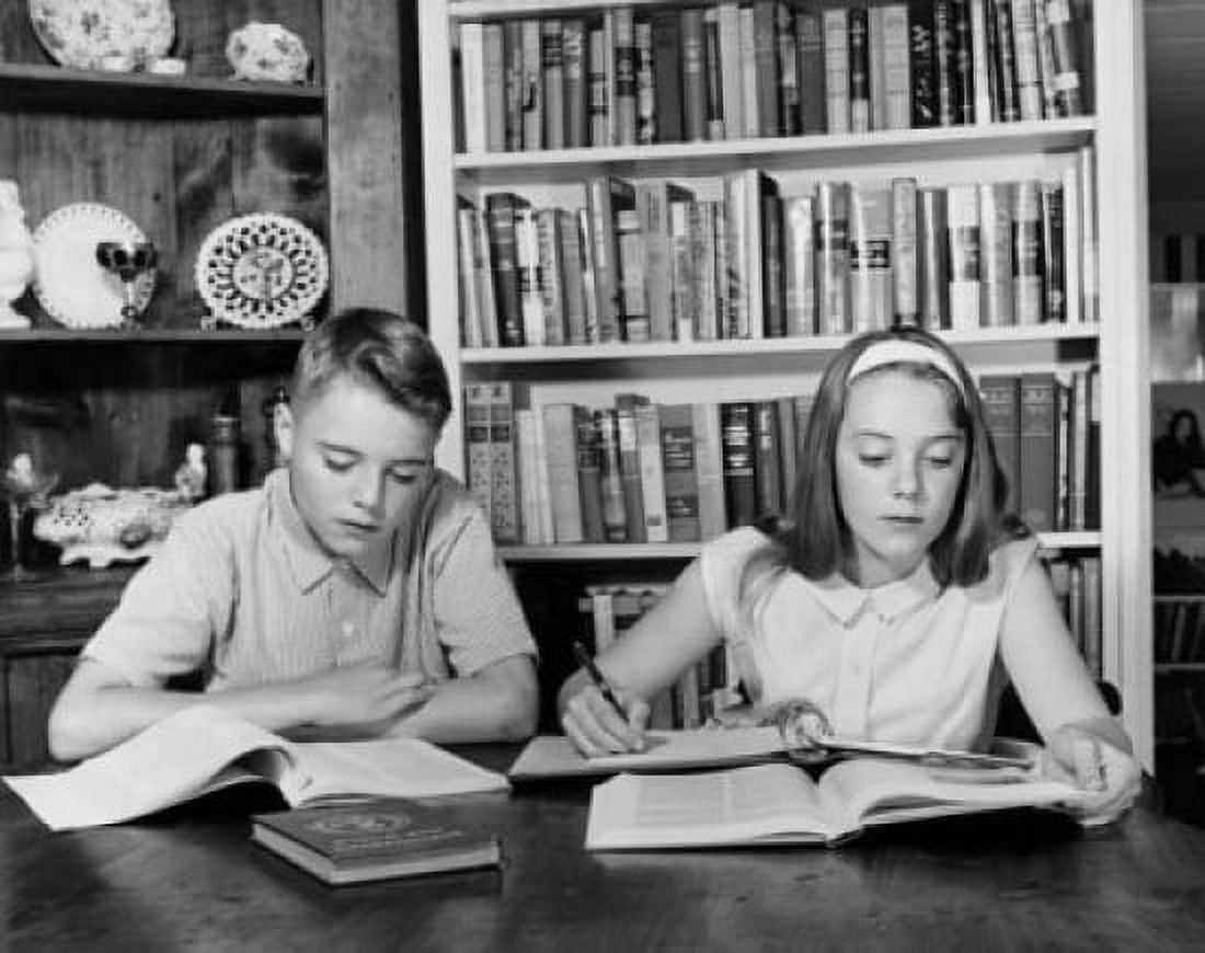 Teenage boy and teenage girl studying at a table Canvas Art - (18 x 24)