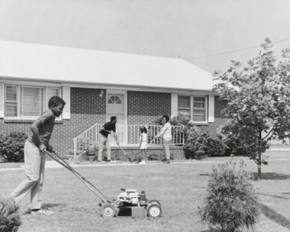 Teenage boy mowing the grass with a lawn mower Canvas Art - (24 x 36)