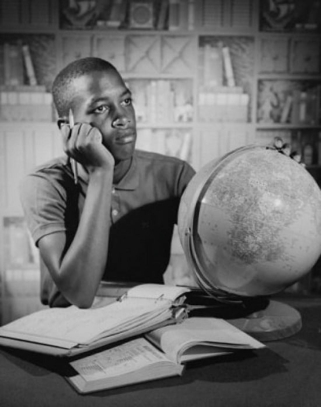 Teenage boy sitting at a table and studying Canvas Art - (18 x 24)