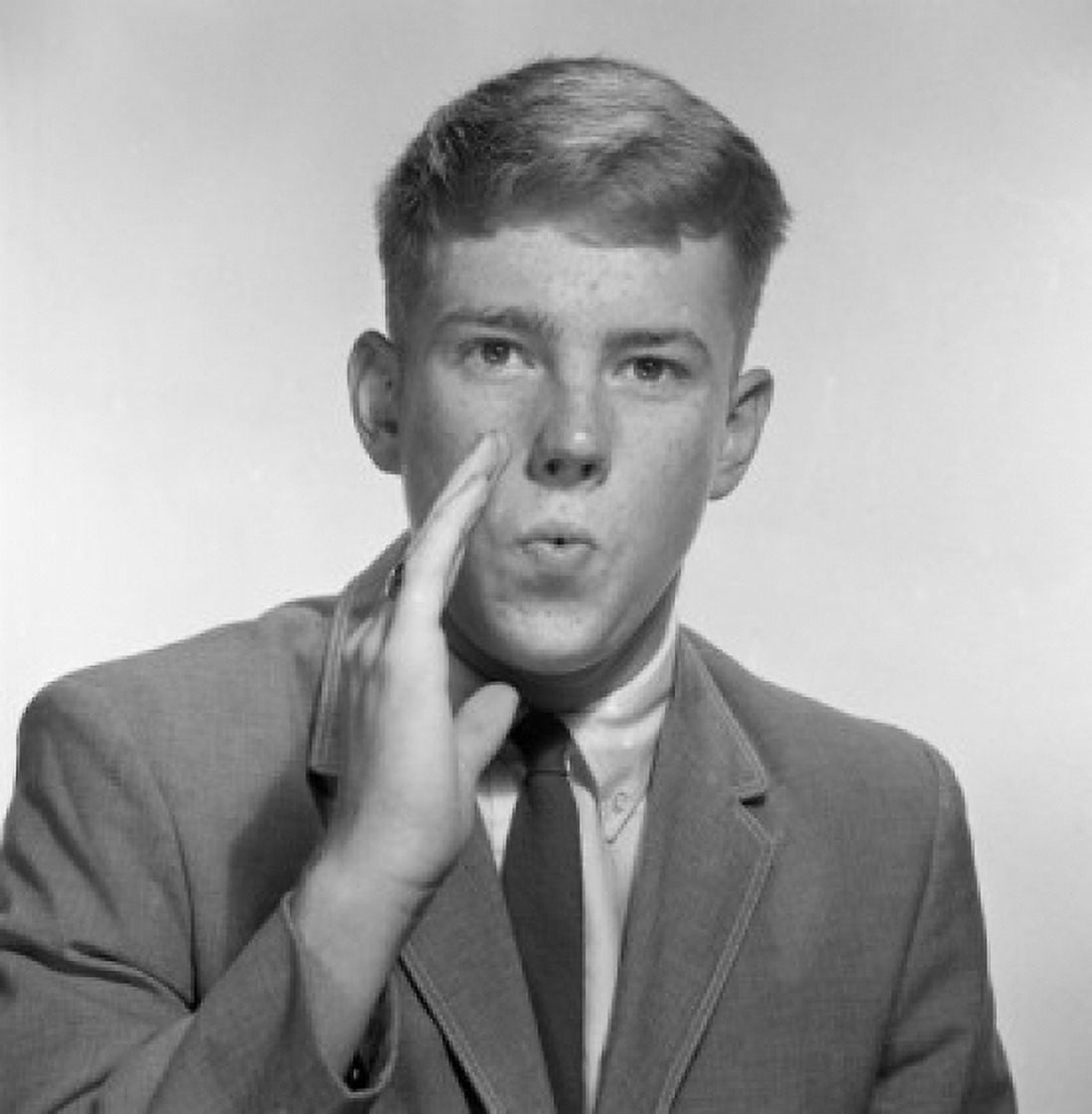 Teenage boy whispering studio shot Canvas Art - (18 x 24)