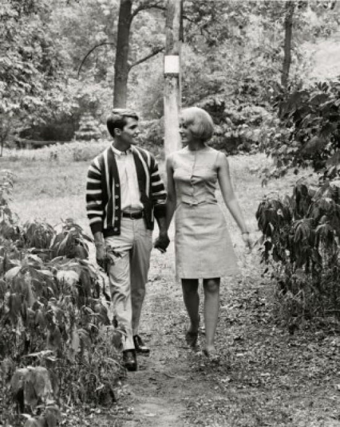 Teenage couple holding hands walking in a garden Canvas Art - (24 x 36)