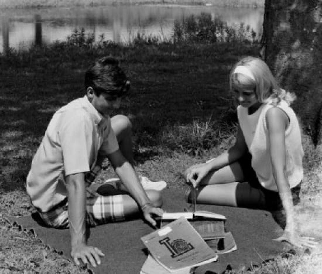 Teenage couple studying under tree Canvas Art - (18 x 24)