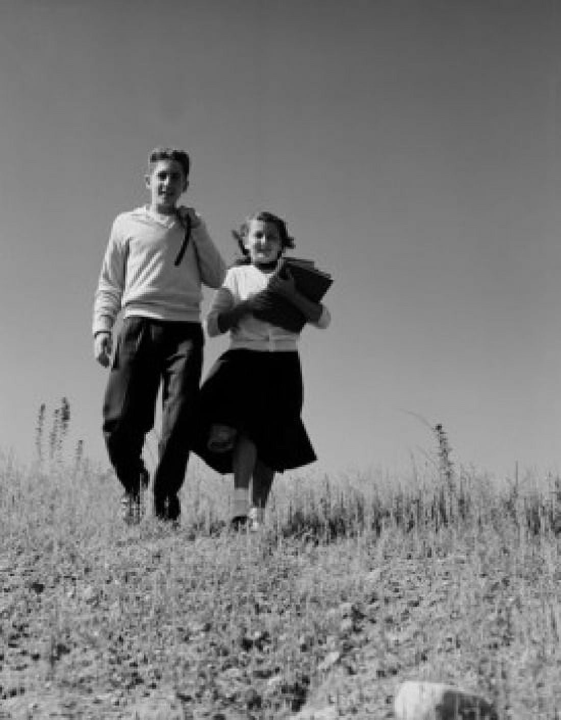 Teenage couple walking from school Canvas Art - (18 x 24)