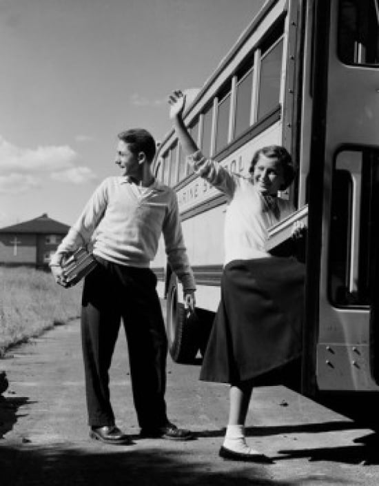 Teenage girl and boy boarding school bus Canvas Art - (24 x 36)