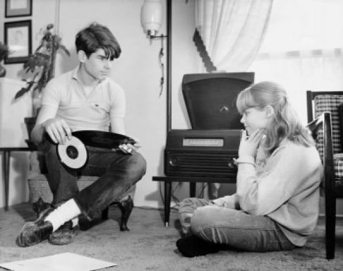 Teenage girl and boy listening to music in home Canvas Art - (24 x 36)