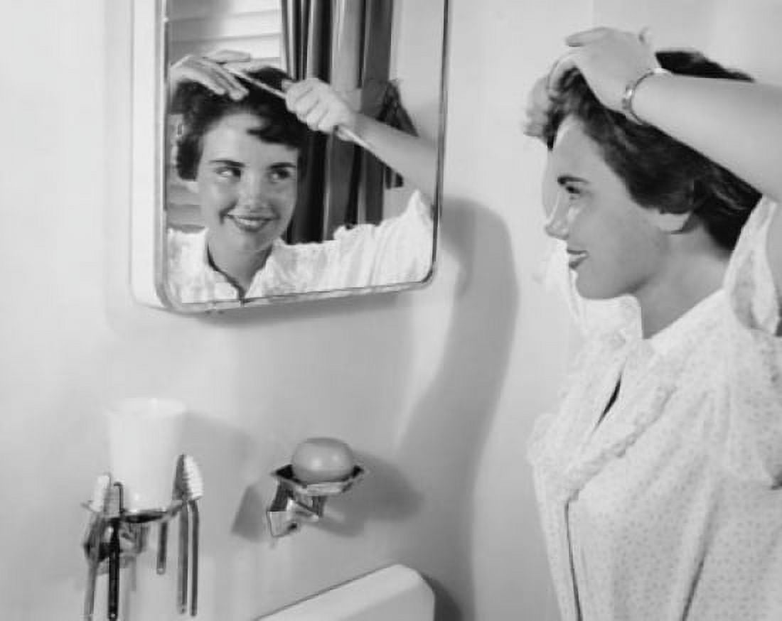 Teenage girl combing her hair and smiling Canvas Art - (24 x 36)