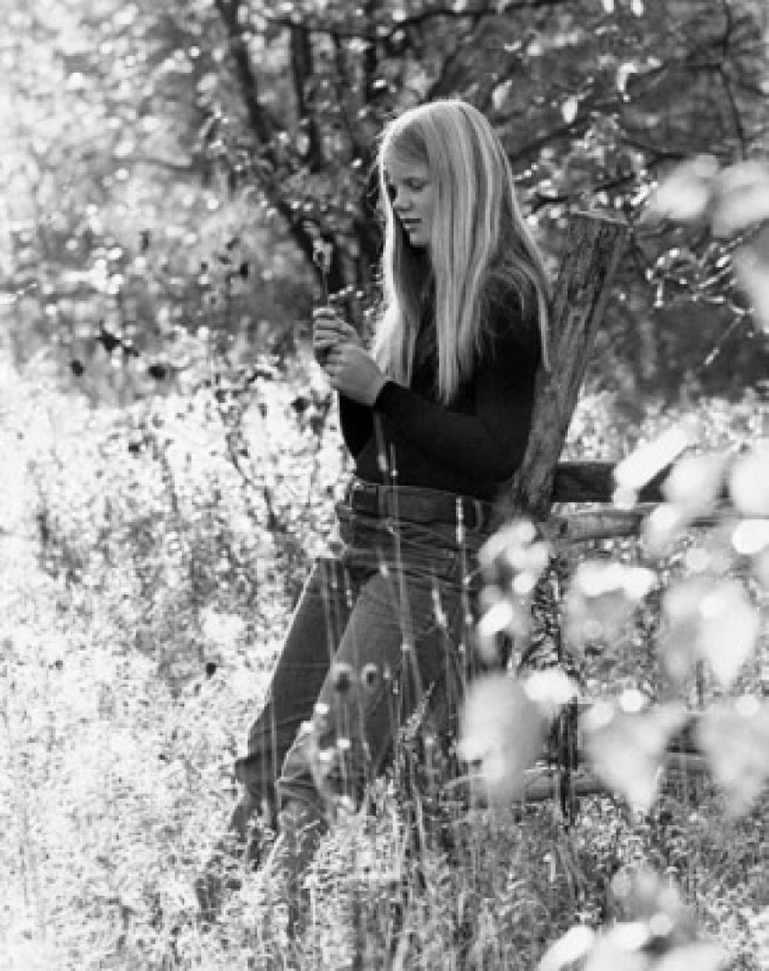 Teenage girl leaning against wooden post on meadow Canvas Art - (18 x 24)