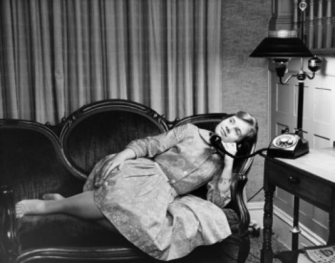Teenage girl lying on a couch and talking on the telephone Canvas Art - (24 x 36)