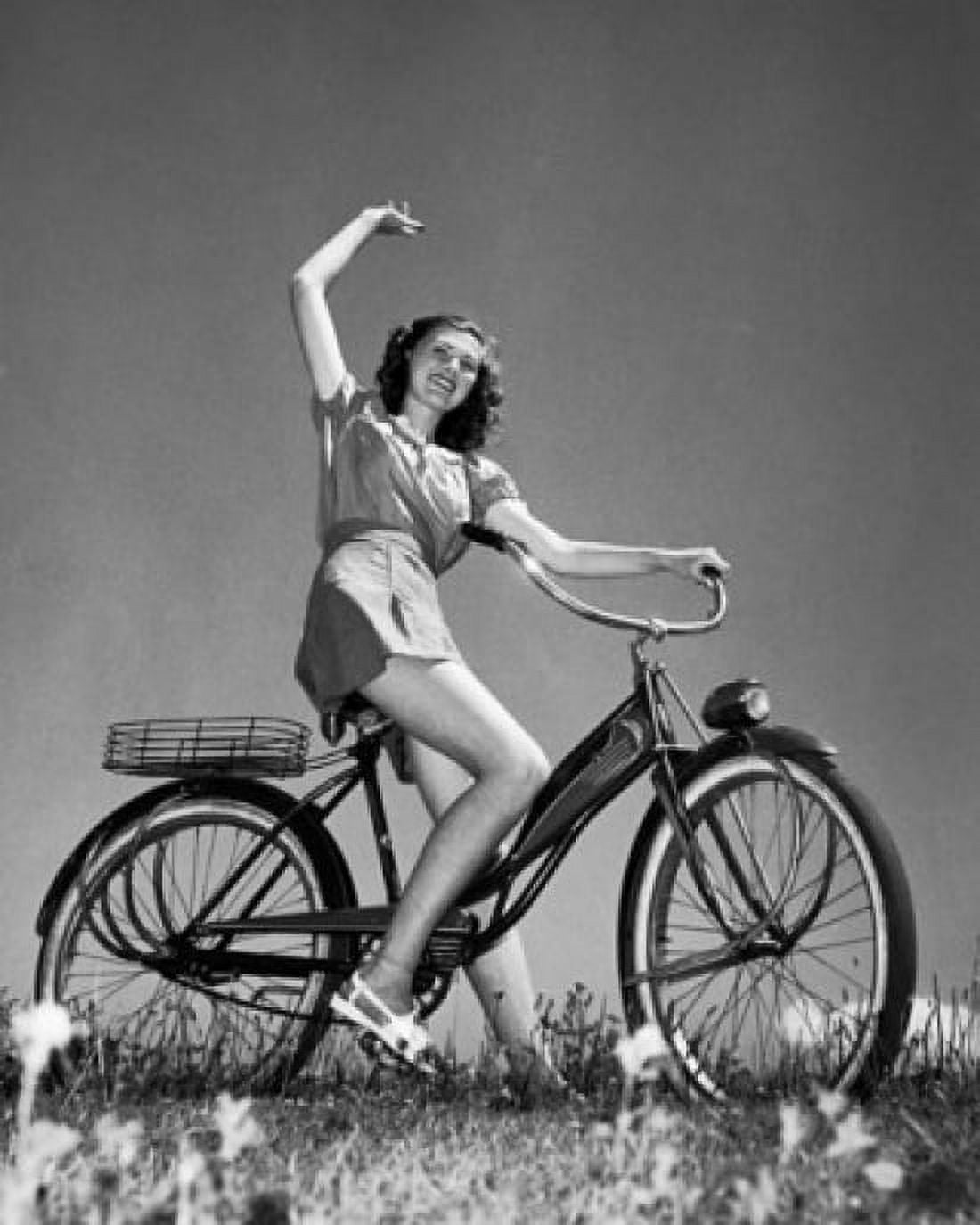 Teenage girl riding a bicycle and smiling Canvas Art - (24 x 36)