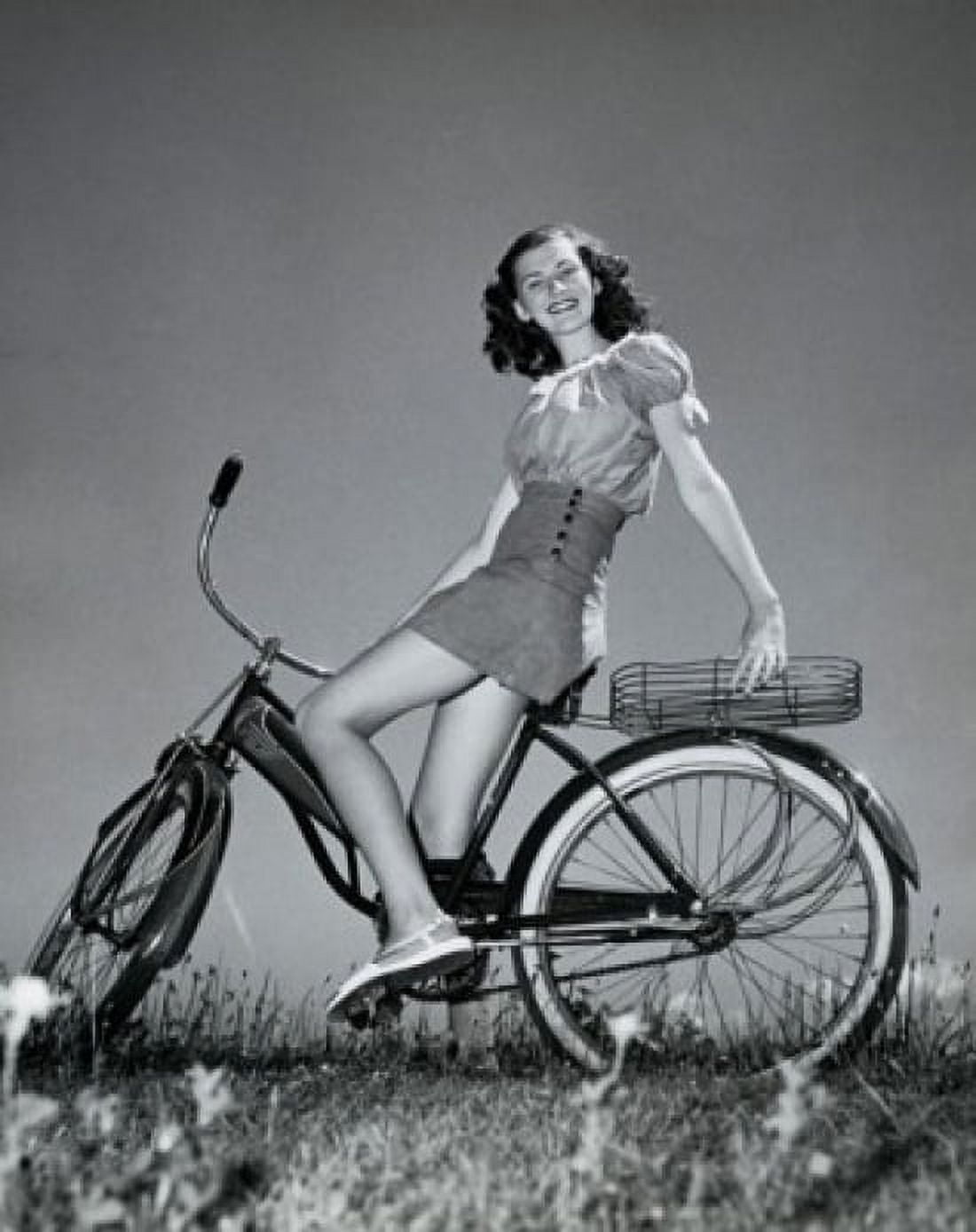 Teenage girl sitting on a bicycle and smiling Canvas Art - (18 x 24)