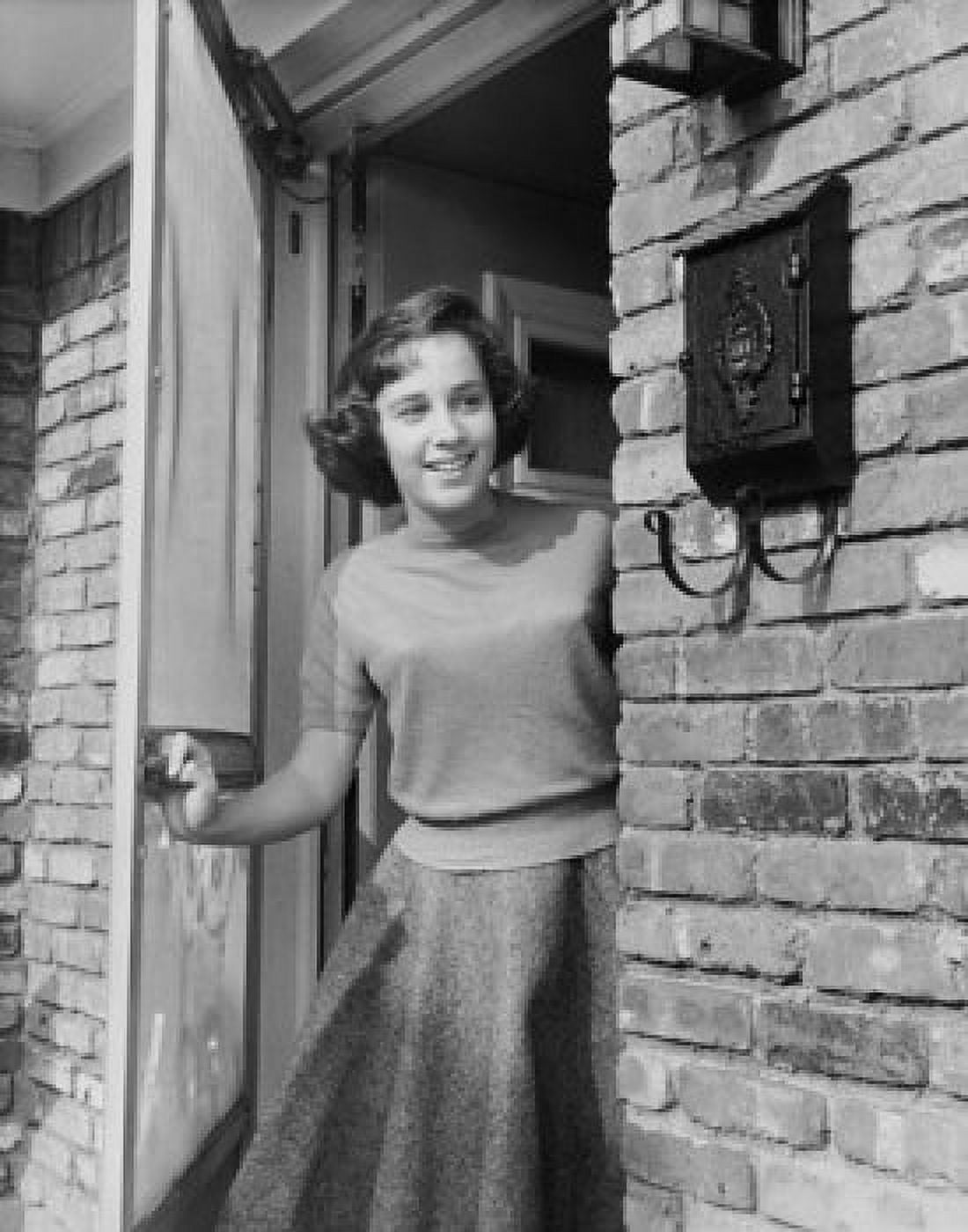 Teenage girl standing at a door and smiling Canvas Art - (18 x 24)