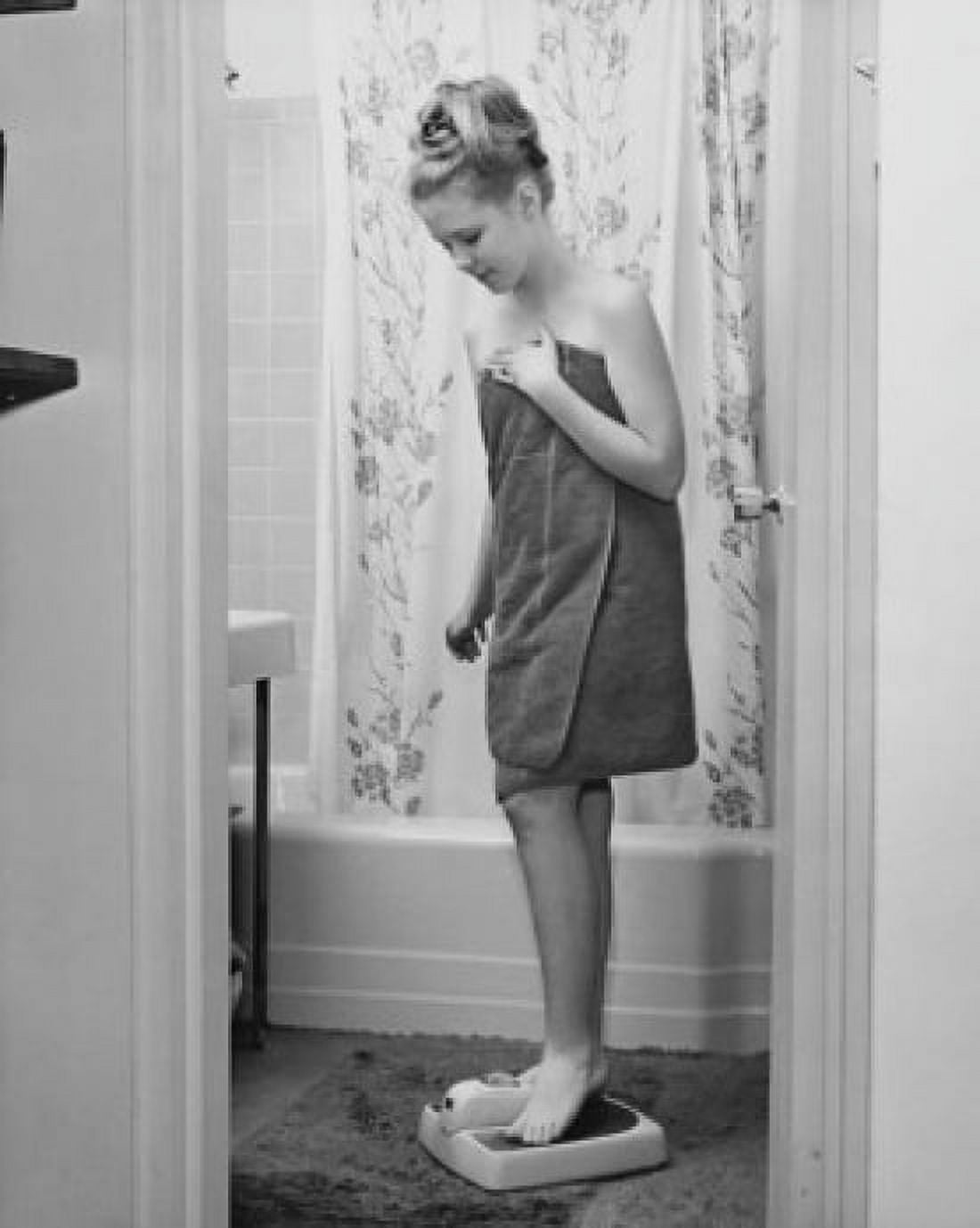 Teenage girl standing on a weight scale Canvas Art - (18 x 24)