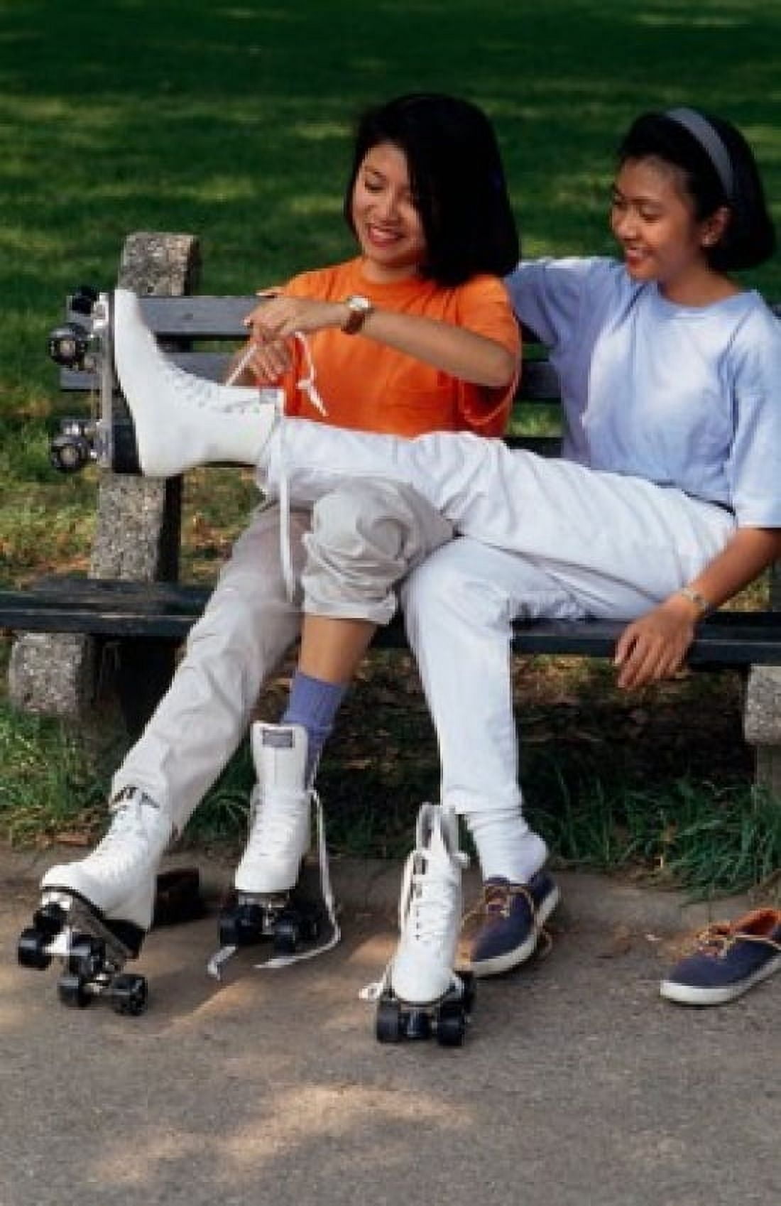 Teenage girl tying the laces of her friends roller skate Canvas Art - (24 x 36)