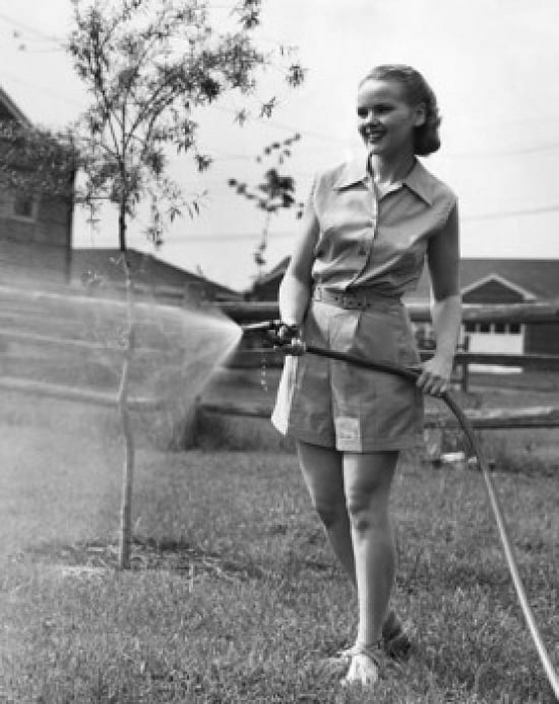 Teenage girl watering lawn Canvas Art - (18 x 24)