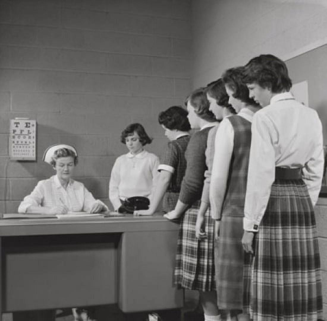 Teenage girls standing in a row beside a nurses desk Canvas Art - (18 x 24)