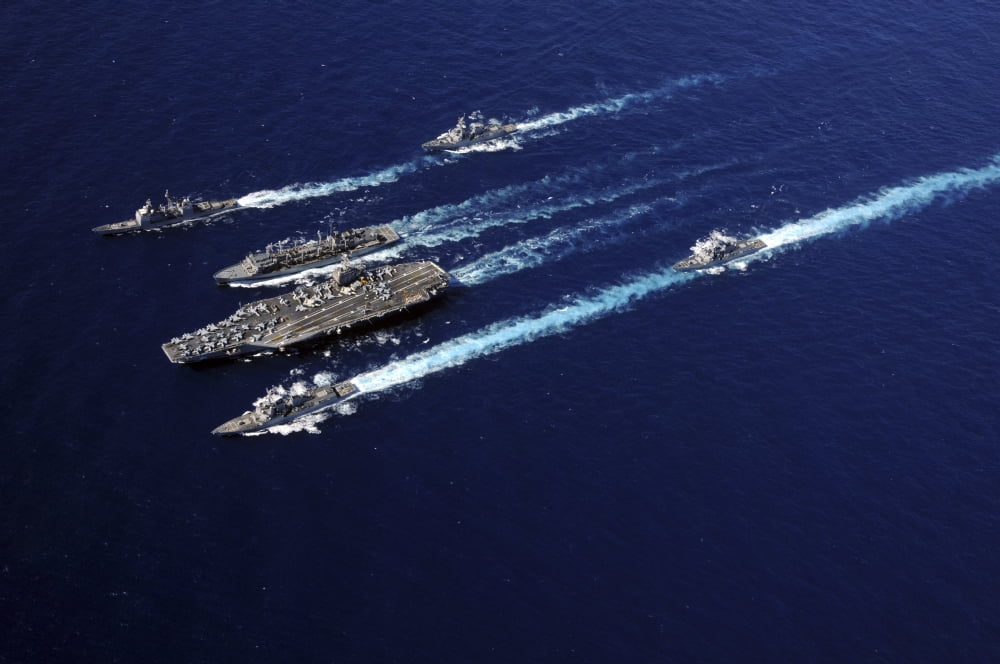 The Abraham Lincoln Carrier Strike Group ships cruise in formation in the Pacific Ocean Canvas Art - Stocktrek Images (34 x 23)